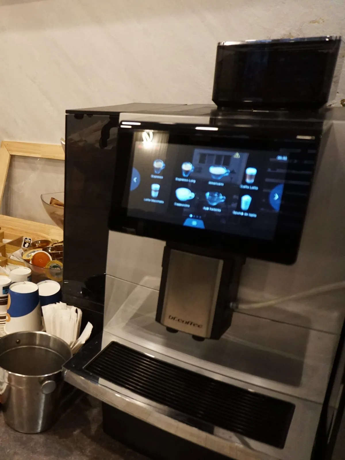 The automatic espresso machine, cups and juice dispensers