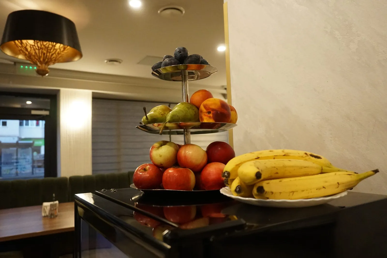Fruit stand with apples, pears, peaches and bananas