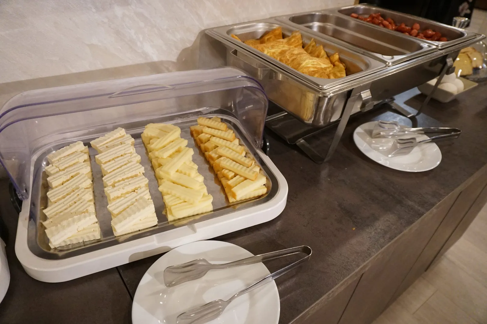 Sliced cheeses under a clear cover