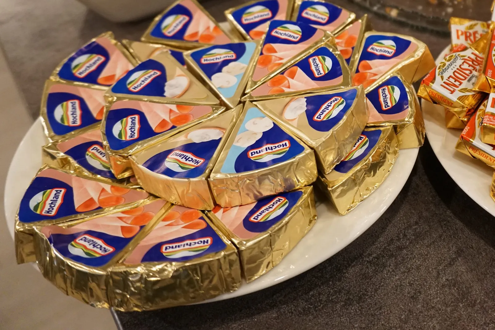 Single portions of butter and processed cheese on the buffet