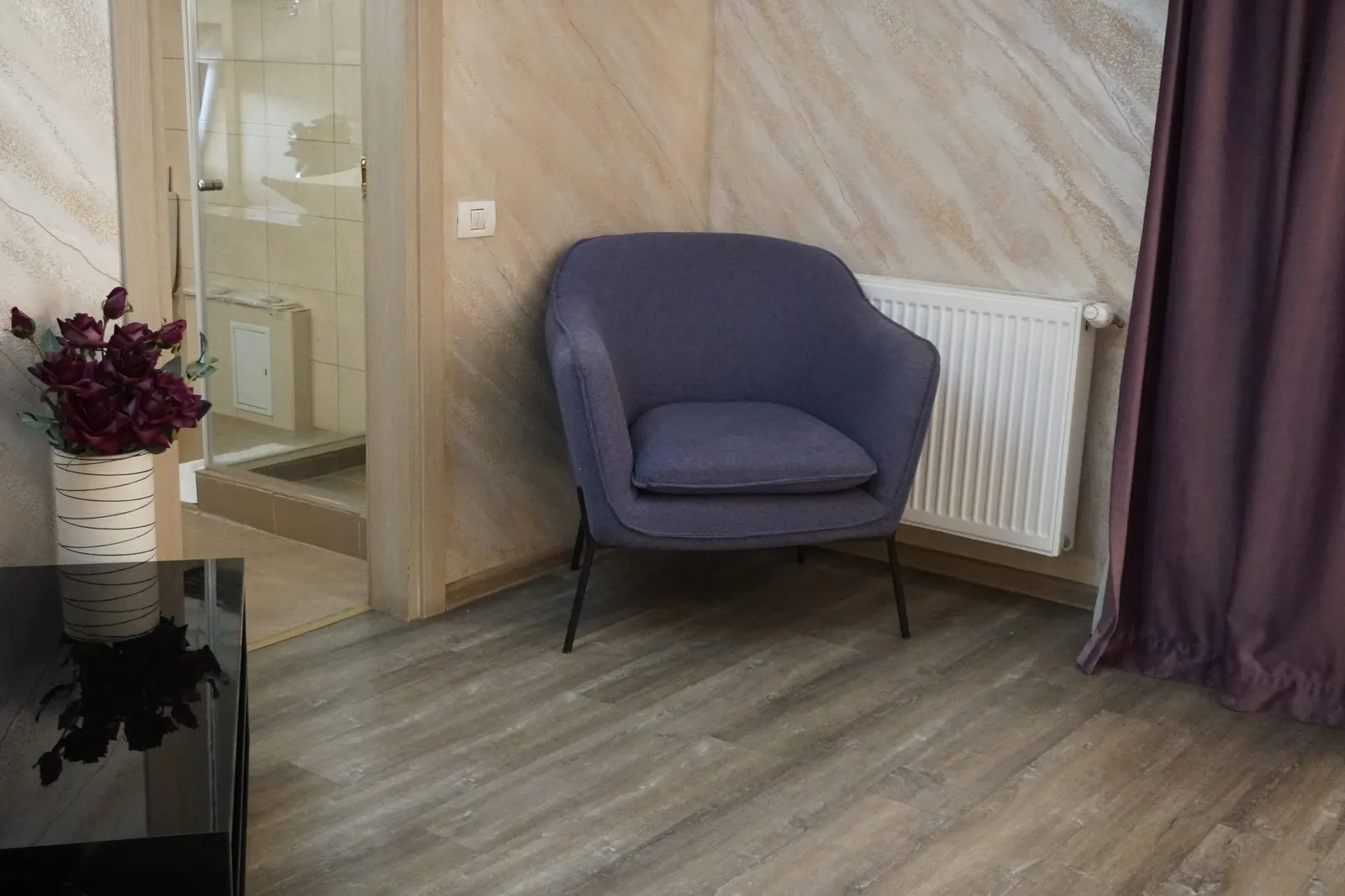 The living room armchair and the door to the bathroom