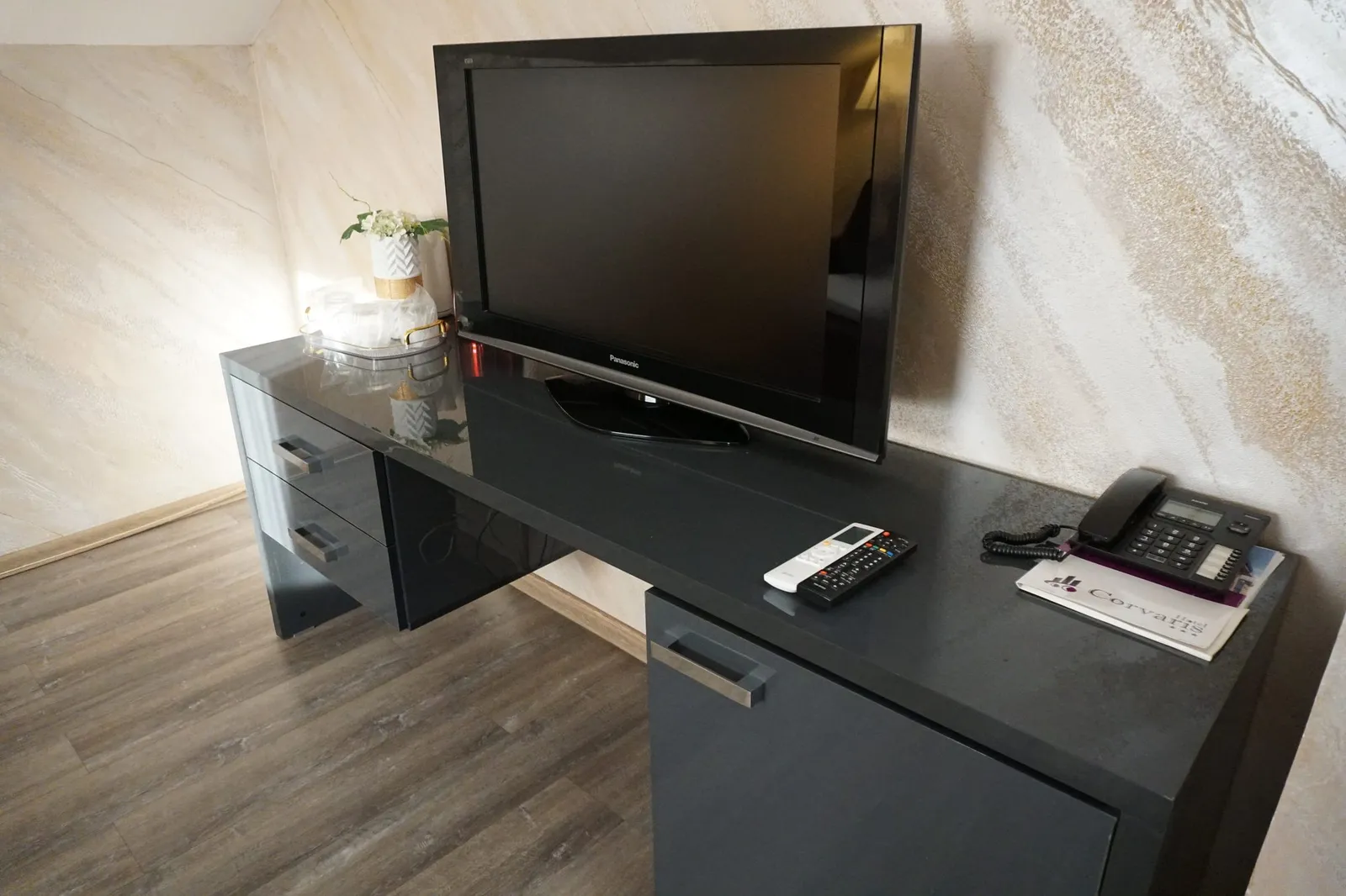 The desk and TV in the apartment's living room