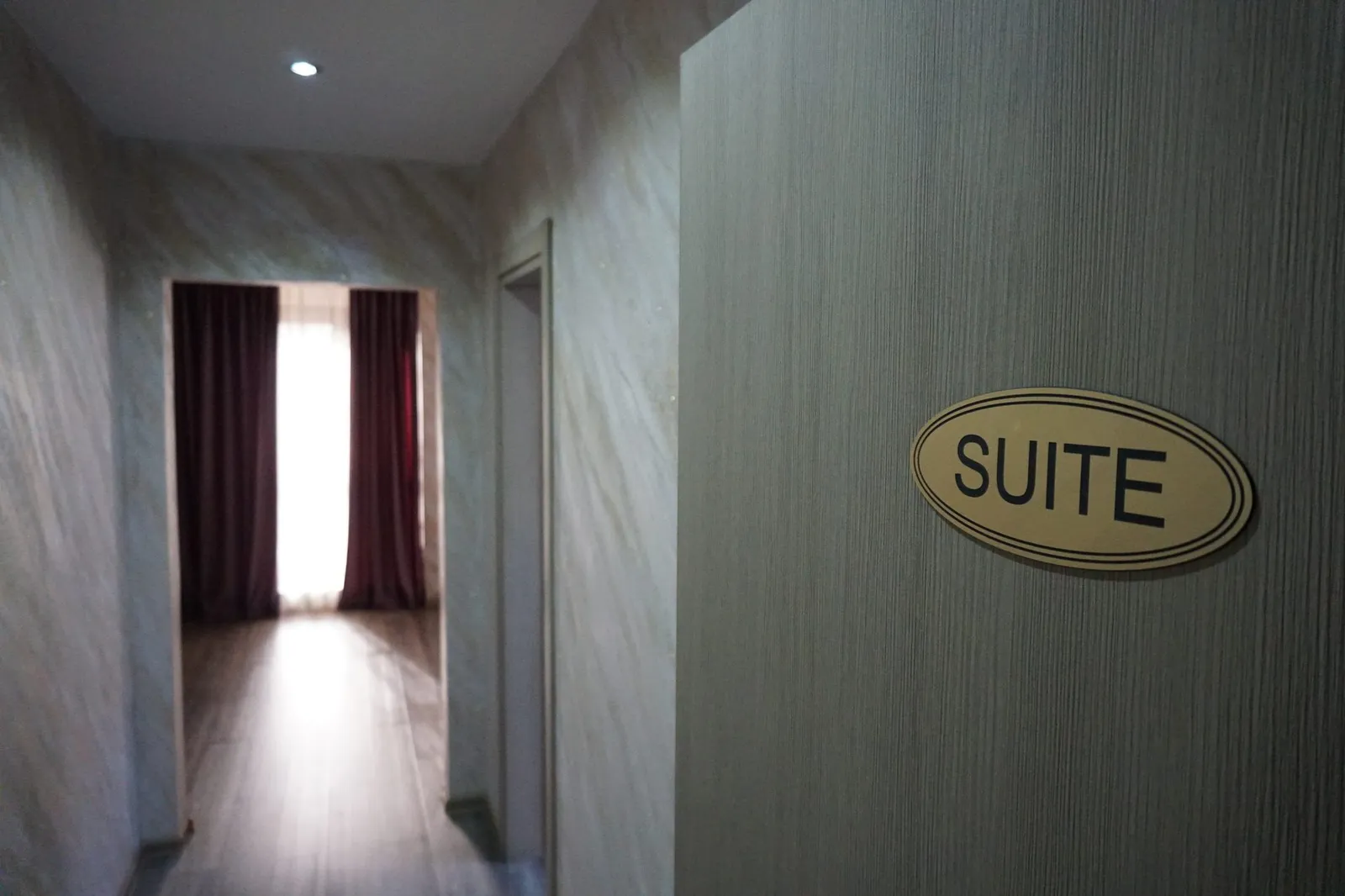 The apartment's entrance hall, with the SUITE sign