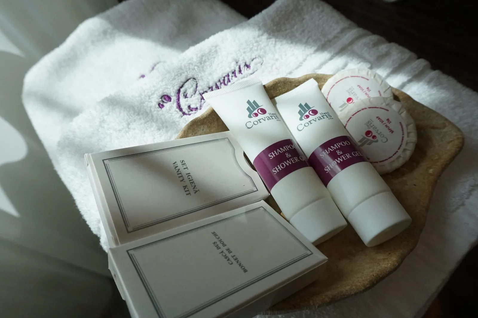Corvaris toiletries on an embroidered towel