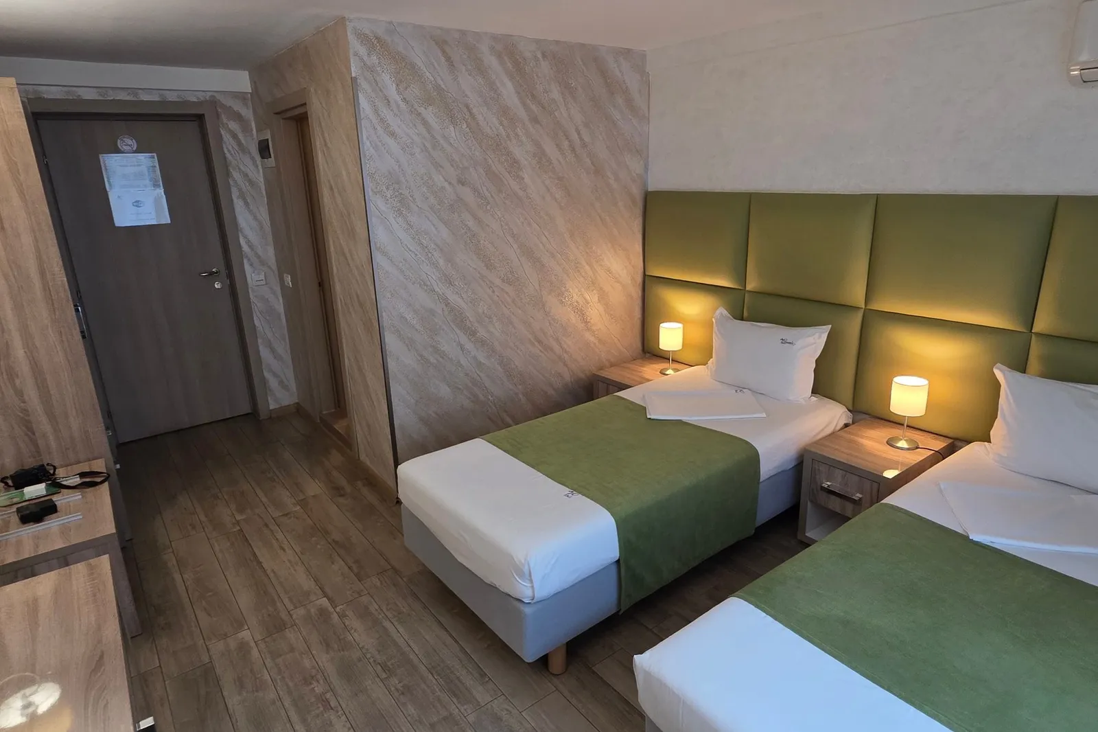 The green twin room, from the window towards the entrance and desk