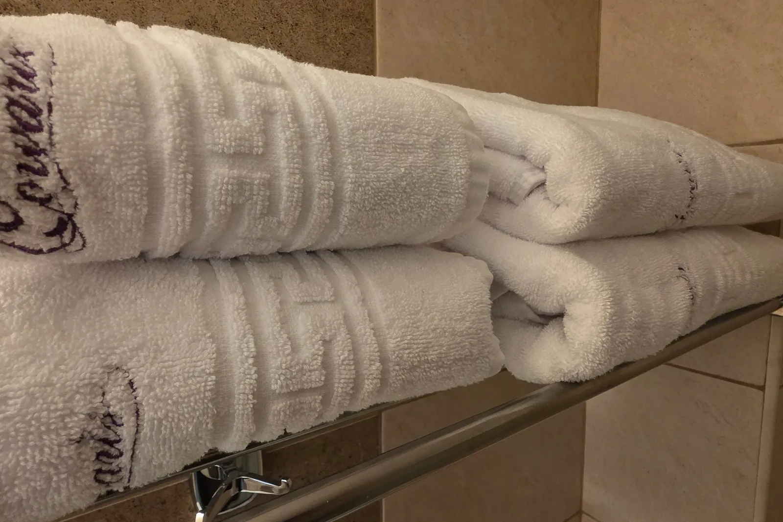 Towels embroidered with the Corvaris logo, on the bathroom rack